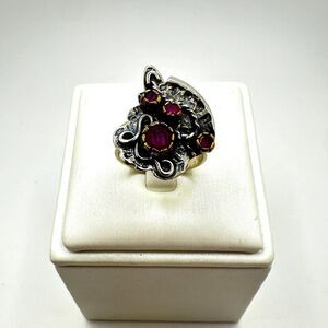 One-of-a-kind, round cut Rubies and Sterling silver two tone custom ring!